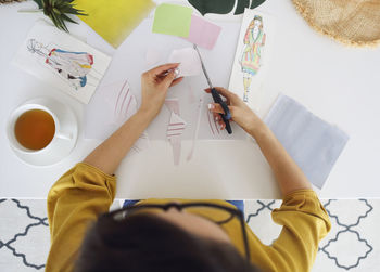 Directly above shot of woman doing craft