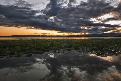 Scenic view of dramatic sky over sea during sunset