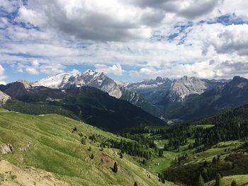 Scenic view of mountains against cloudy sky