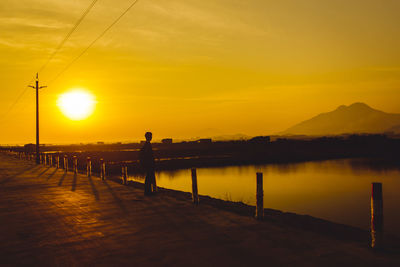 Scenic view of lake against sky during sunset