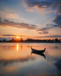 Scenic view of lake against sky during sunset