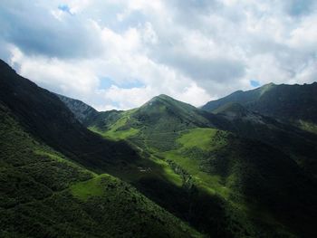 Scenic view of mountains against cloudy sky