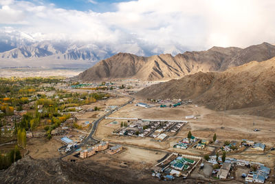 High angle view of land and mountains against sky