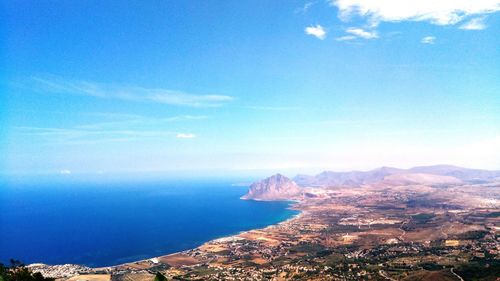 Scenic view of sea and mountains against sky