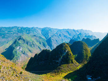 Scenic view of mountains against clear blue sky