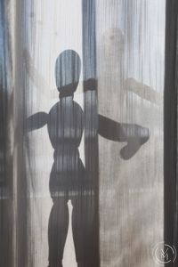 Digital composite image of person standing by window