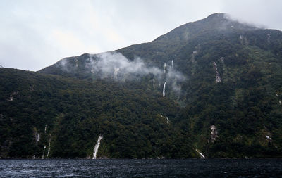 Sea against waterfalls on mountain sea at te anau