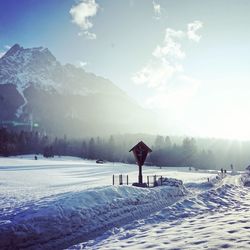 Scenic view of snow covered landscape against sky