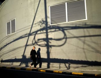 Man walking by building in city