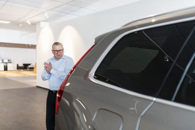 Man in car showroom