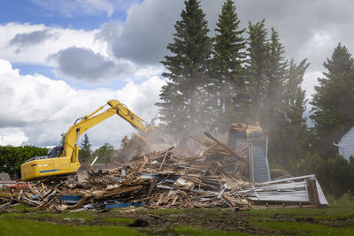 Abandoned construction site on field against sky