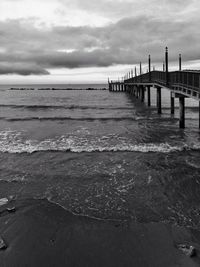 Pier over sea against sky