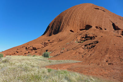 Scenic view of desert against clear blue sky