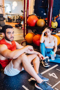 Portrait of young woman exercising in gym