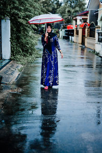 Rear view of woman standing in water