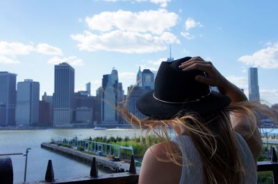 Midsection of woman in city against sky