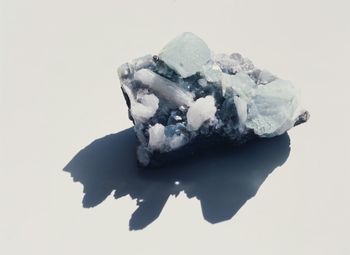 High angle view of ice cream on rock against white background