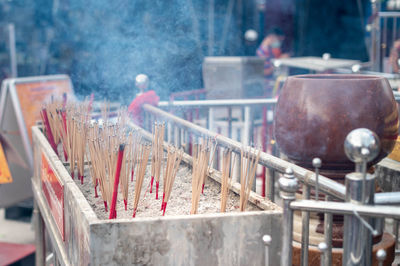 Many incense sticks are put in the pot to pay for buddhists in the temple of thailand.