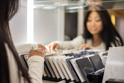 Woman choosing tile at shop