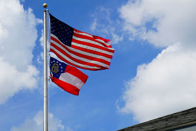 Low angle view of american flag against sky