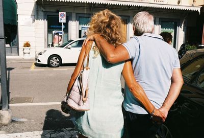 Rear view of people on street in city