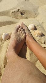 Low section of people on sand at beach