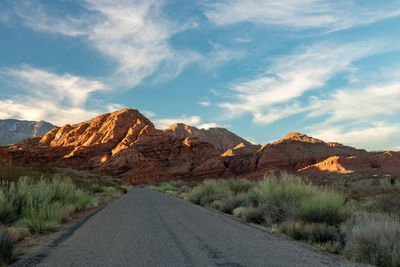 Road by mountain against sky