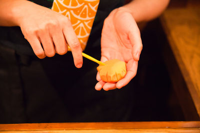 Cropped image of hands making food