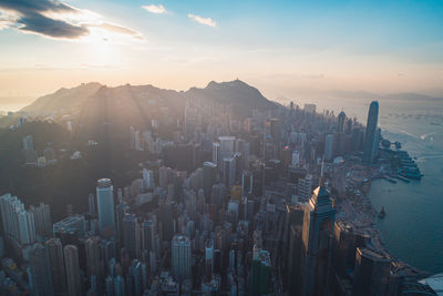 Panoramic shot of city buildings against sky during sunset