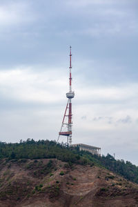 Low angle view of communications tower against sky