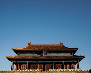 Low angle view of temple against clear blue sky