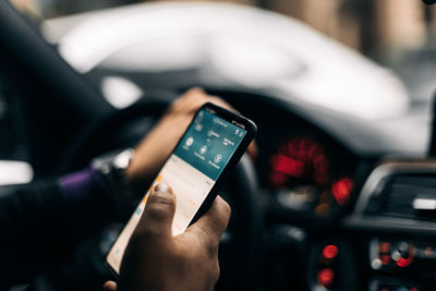 Midsection of man using mobile phone