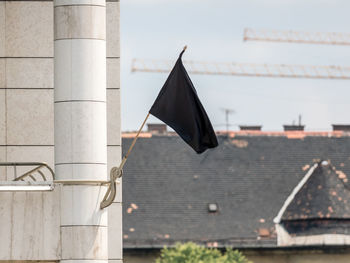 Close-up of black flag on architectural column