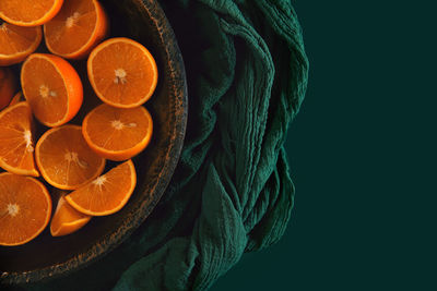 Close-up of orange fruit against black background