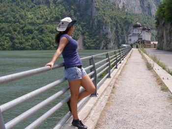 Full length of woman on railing against trees