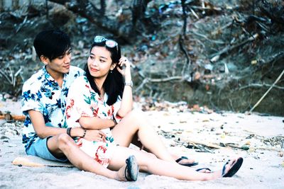 Young couple sitting outdoors