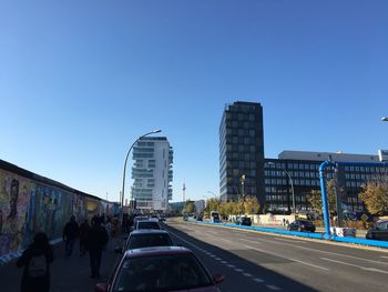 View of city street against blue sky