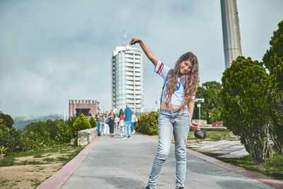 Full length of young woman standing on street