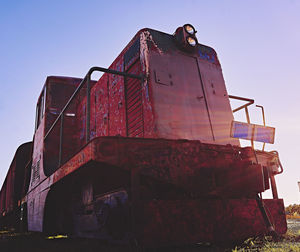 Low angle view of rusty vehicle against clear sky