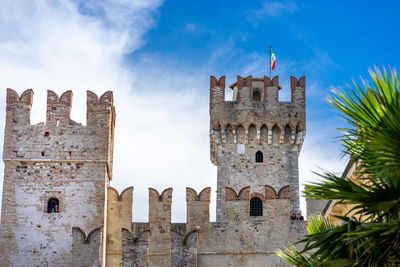 Sirmione castle with italian flag in the background