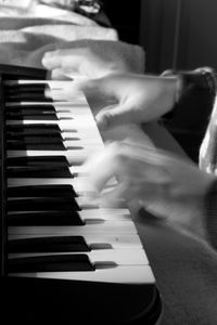 Close-up of hands playing piano