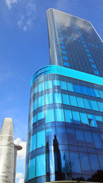 Low angle view of office building against blue sky