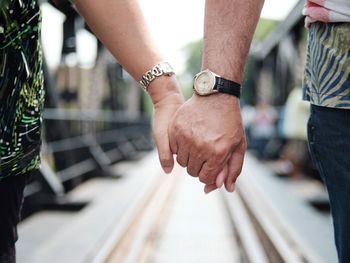 Close-up of couple holding hands