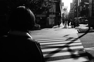 Rear view of woman walking on street