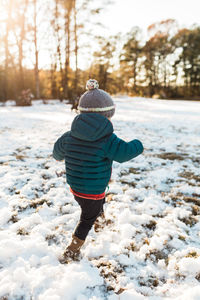 Rear view of boy in snow