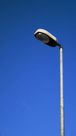 Low angle view of metallic structure against blue sky