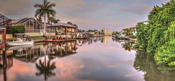 Sunrise over a waterway leading to the ocean near vanderbilt beach in naples, florida.