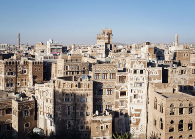 Buildings in city against clear sky