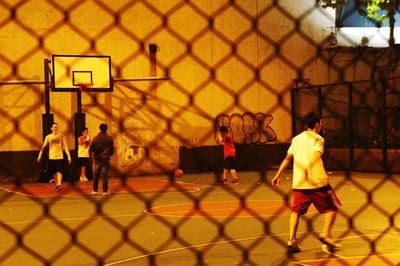 Group of people playing basketball court