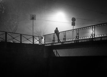 Low angle view of silhouette man standing on steps